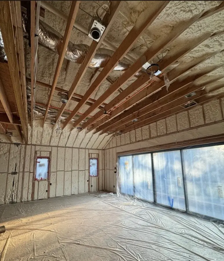 Interior walls and ceiling insulated with spray foam during new construction in Cohasset